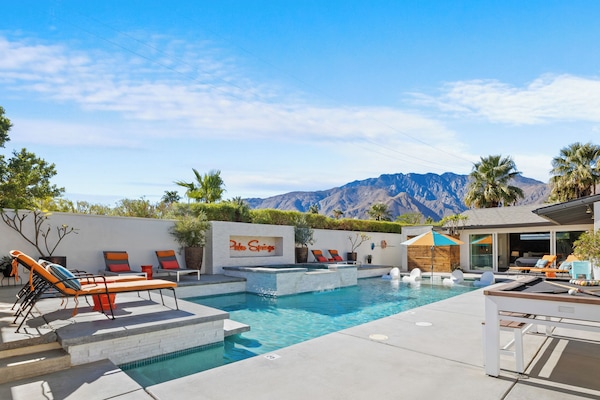 Backyard large pool and jacuzzi, grill, bar area, and fire pit in Palm Springs