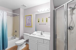 A bathroom with a bathtub, toilet, vanity with sink, and a shower area. - Amalfi Coast 213B - Community Pool, Fitness Facility, Gulf Views, Miramar Beach! (Miramar Beach)