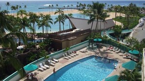 A resort with a swimming pool, beach, and palm trees. - Unobstructed Ocean View Suite. Don't miss out on the last-minute special rate! (Honolulu)