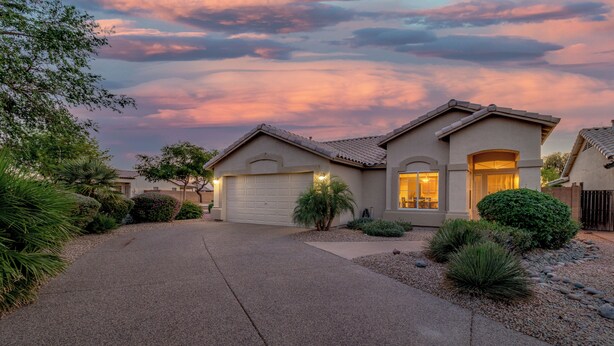 A two-story house with a garage, surrounded by landscaped gardens and a driveway. - 3BR w pool, putting green, fire pit (Gilbert)