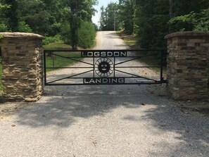 A gated entrance with 'LOGSDON LANDING' and a sun symbol.