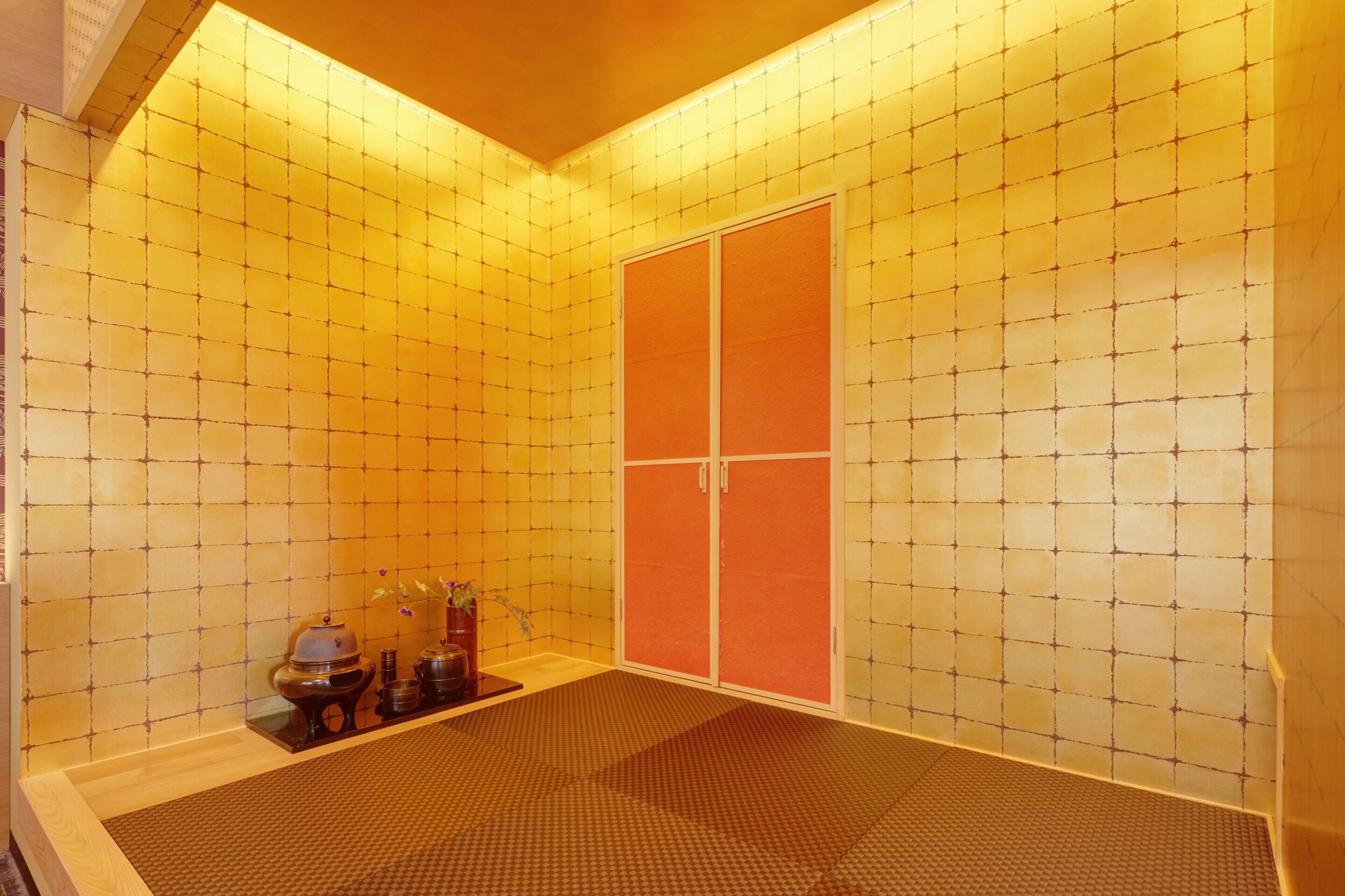 A room with a tiled floor, a wooden bench, a cabinet, and a sliding door.