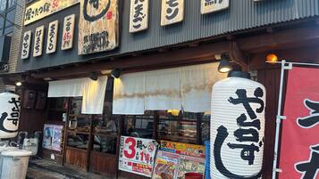 A traditional Japanese restaurant with wooden signage and lanterns.