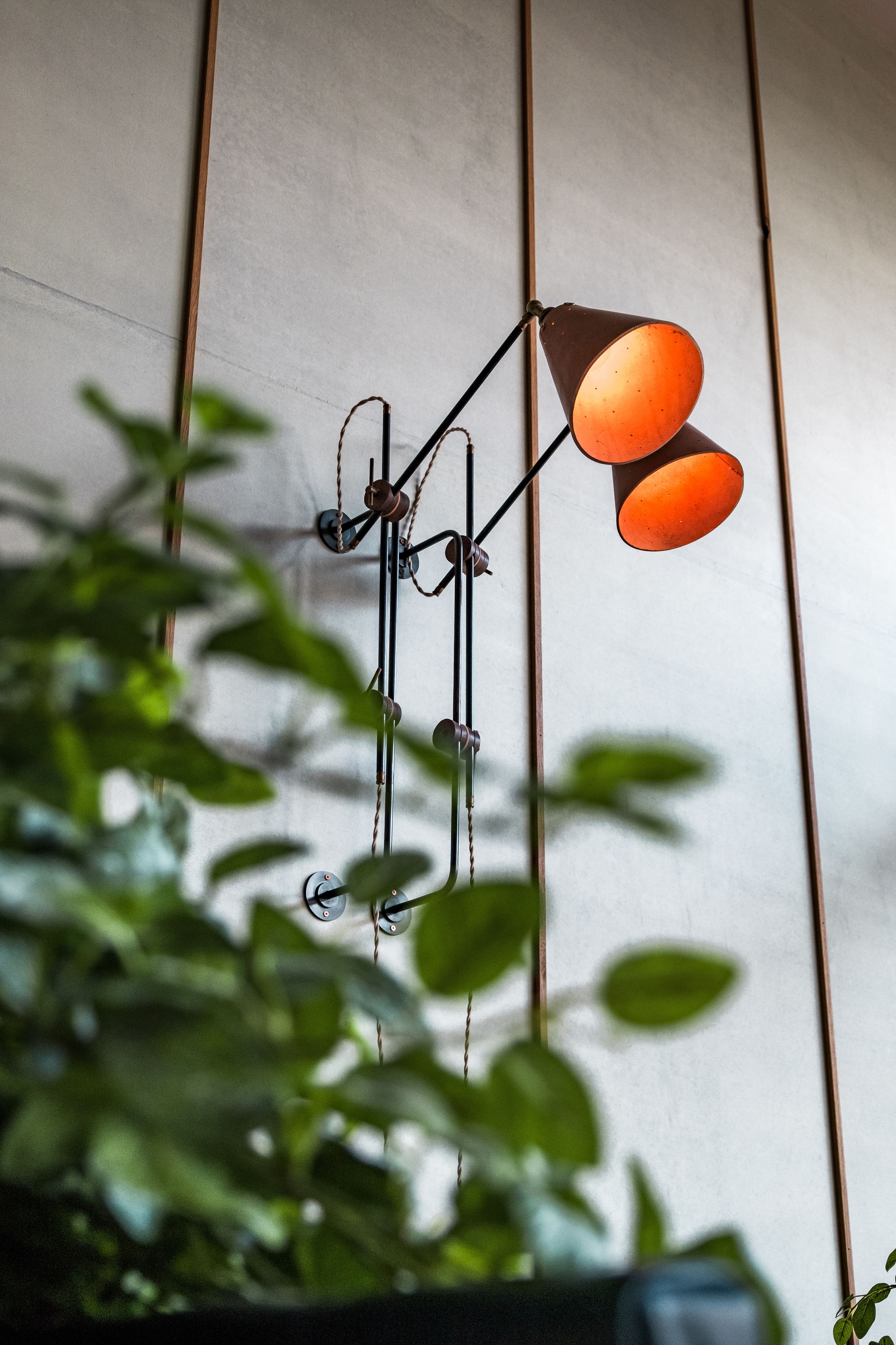 A wall-mounted light fixture with three bulbs.