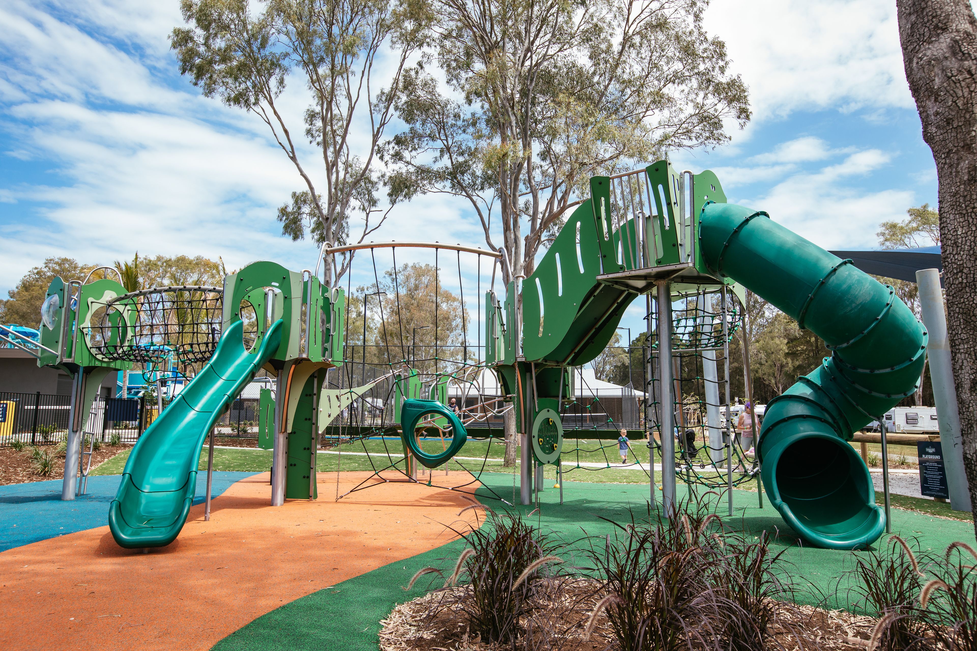 A playground with multiple slides and climbing structures.