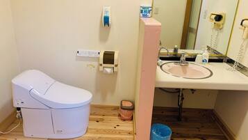 Ein Badezimmer mit Toilette, Waschbecken und Handtrockner.