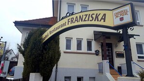 A hotel entrance with a sign reading "Hotel Restaurant Franziska" and "Dinkelacker" logo. - Gasthof Franziska (Stuttgart)