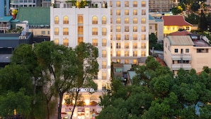 A hotel with a central courtyard, surrounded by trees, and multiple floors with balconies. - T-Ritz Saigon Hotel & Apartment (Ho Chi Minh City)