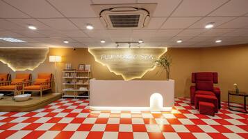 A reception area with a checkered floor, a reception desk, and seating areas.