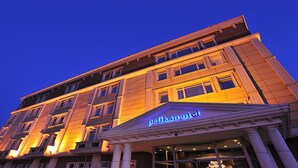 A hotel with a classical facade and illuminated signage. - Pelikan Otel (Istanbul)