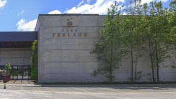 A building with a sign reading "Casa Perlage" and a "Bistro By Chef Antoniais" adjacent to it.