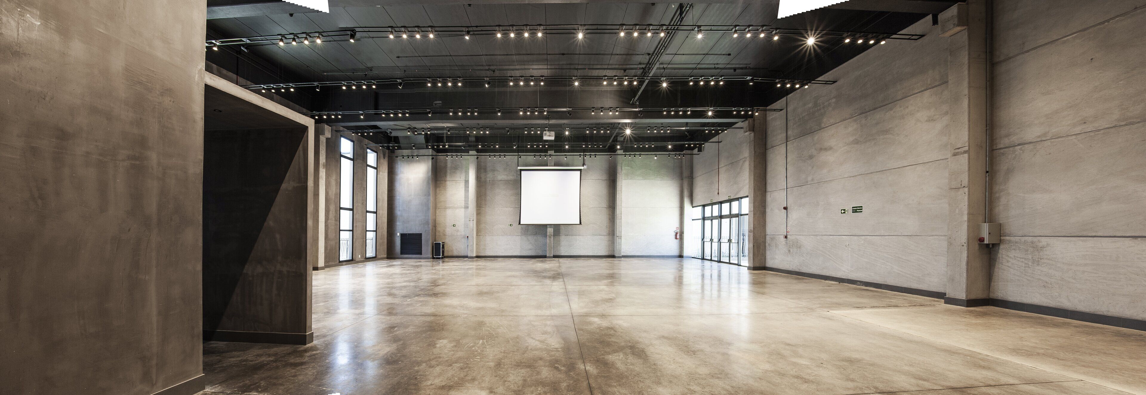 A spacious, modern interior with a polished concrete floor and exposed ceiling lighting.