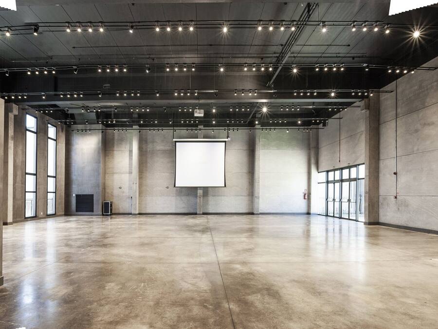 A spacious, modern interior with a polished concrete floor and exposed ceiling lighting.
