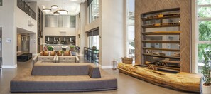 A spacious lobby with a seating area, a fireplace, and a large window. - Holiday Inn Express Farroupilha by IHG (Farroupilha)