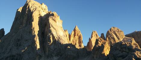 A rugged mountain landscape with sharp peaks and a clear sky.