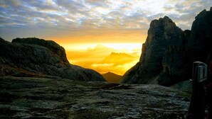 A rugged landscape with rocky terrain and a sunset. - Rifugio Mulaz (Falcade)