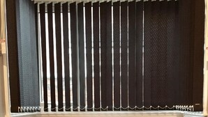 A dining area with a table set for two, a window with vertical blinds, and a bench on either side of the table. - Samuel Place (Crewe)