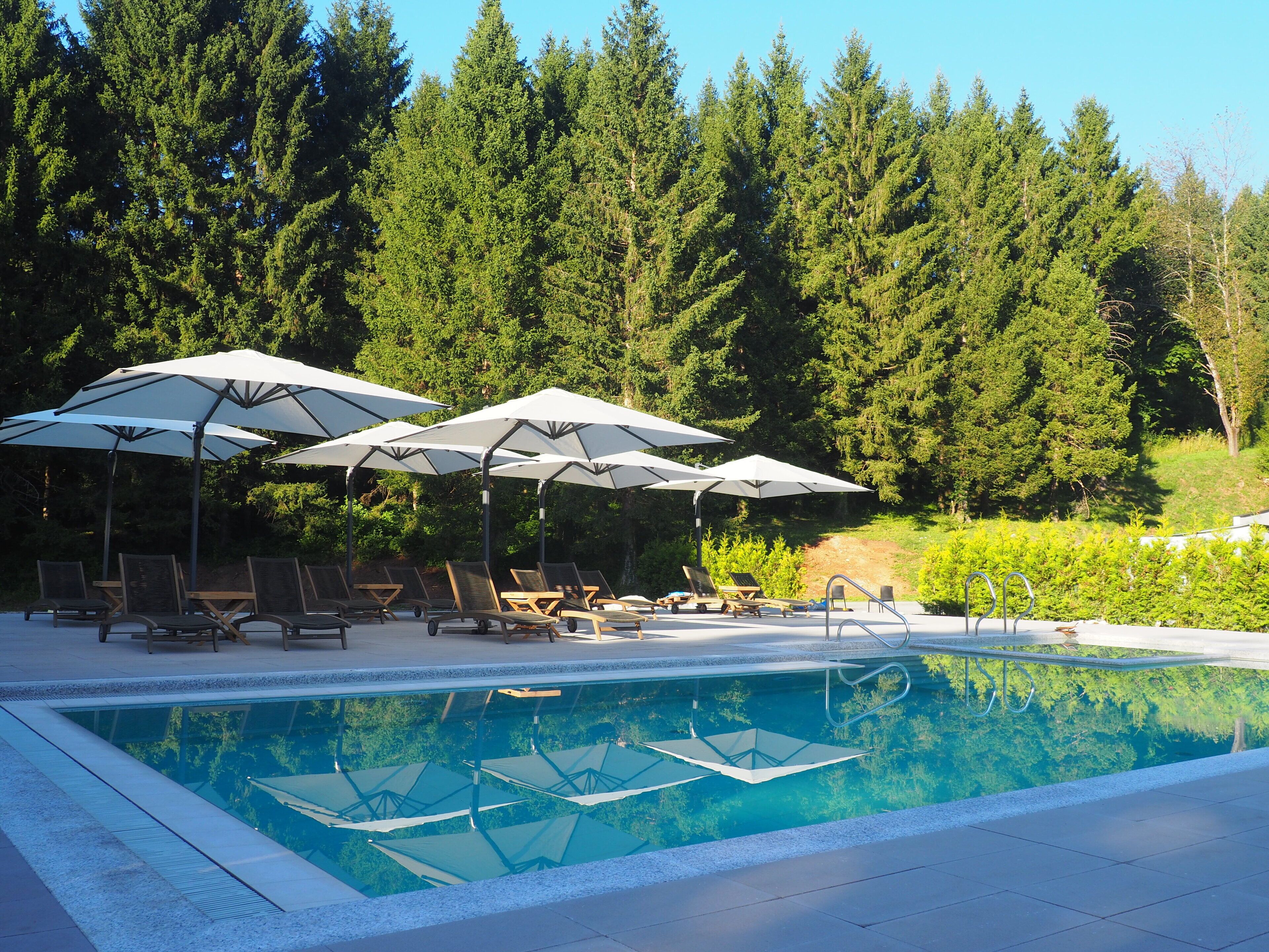 seasonal outdoor pool, open 8:00 am to 8:00 pm, pool umbrellas