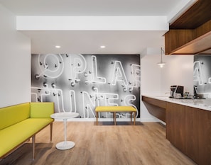 A modern interior with a seating area, a counter, and a wall with a light-up design.