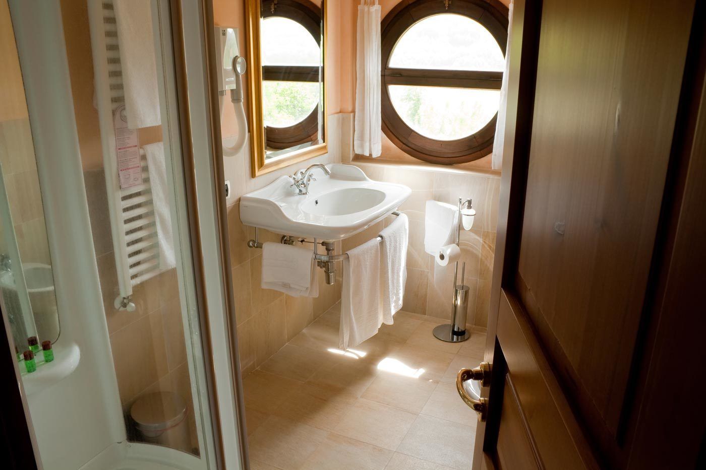A bathroom with a sink, toilet, and shower.