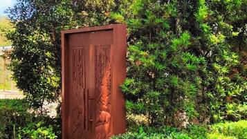 Stroll through the serene garden, surrounded by lush greenery and a beautifully designed entrance.