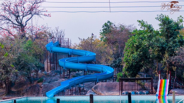 A water slide structure with a pool at the bottom. - Stephen Margolis Resort (Harare)