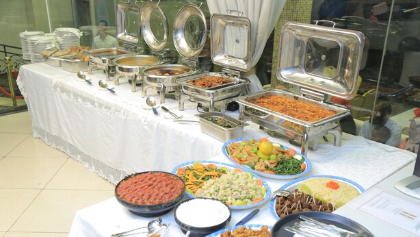A buffet table with various food dishes and serving utensils. - Haven Hotel (Addis Ababa)
