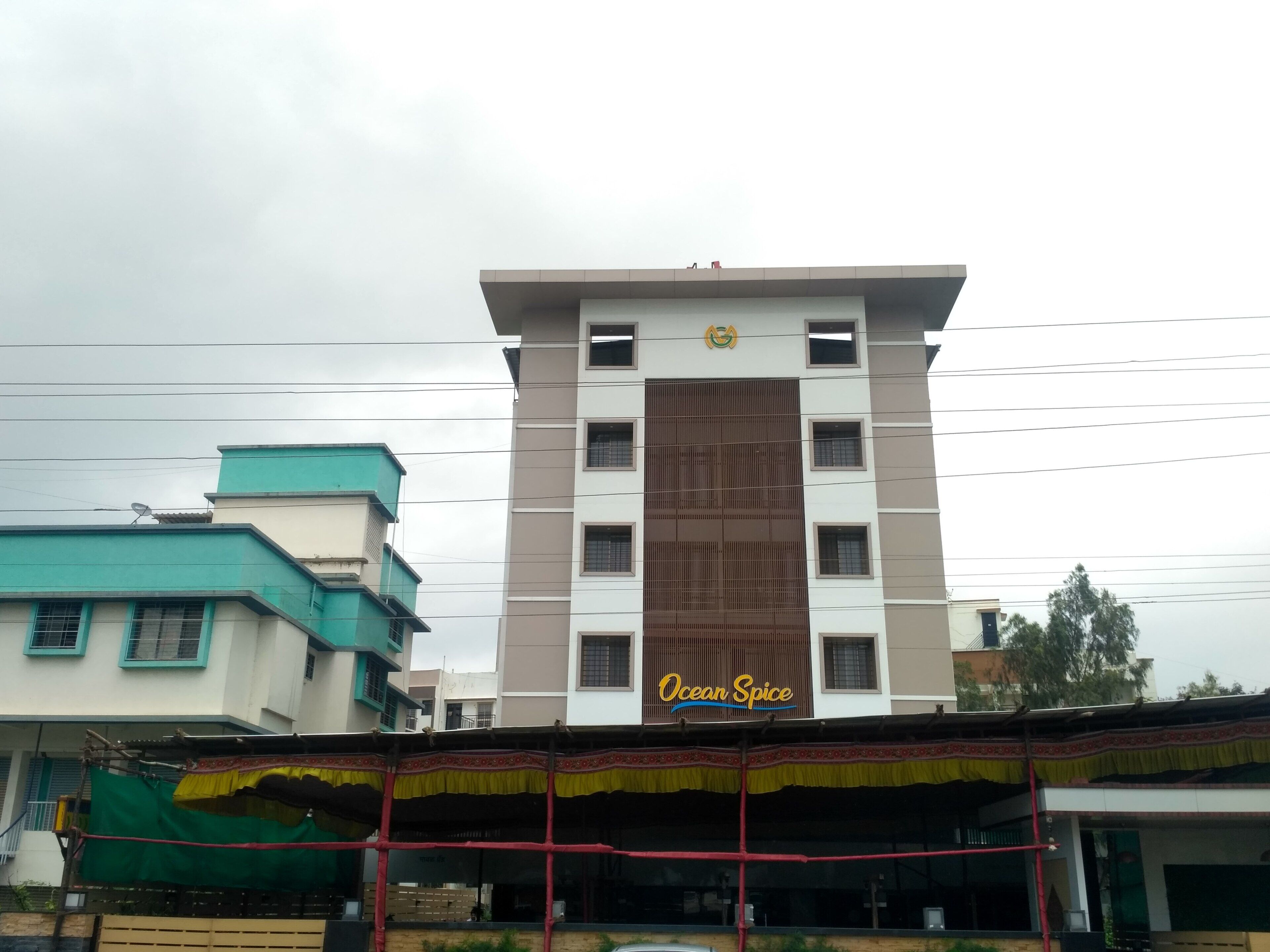 A multi-story building with a sign reading "Ocean Spice".