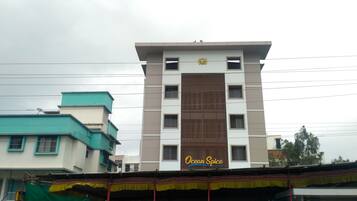 A multi-story building with a sign reading "Ocean Spice".