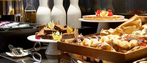 A buffet with various desserts and pastries.