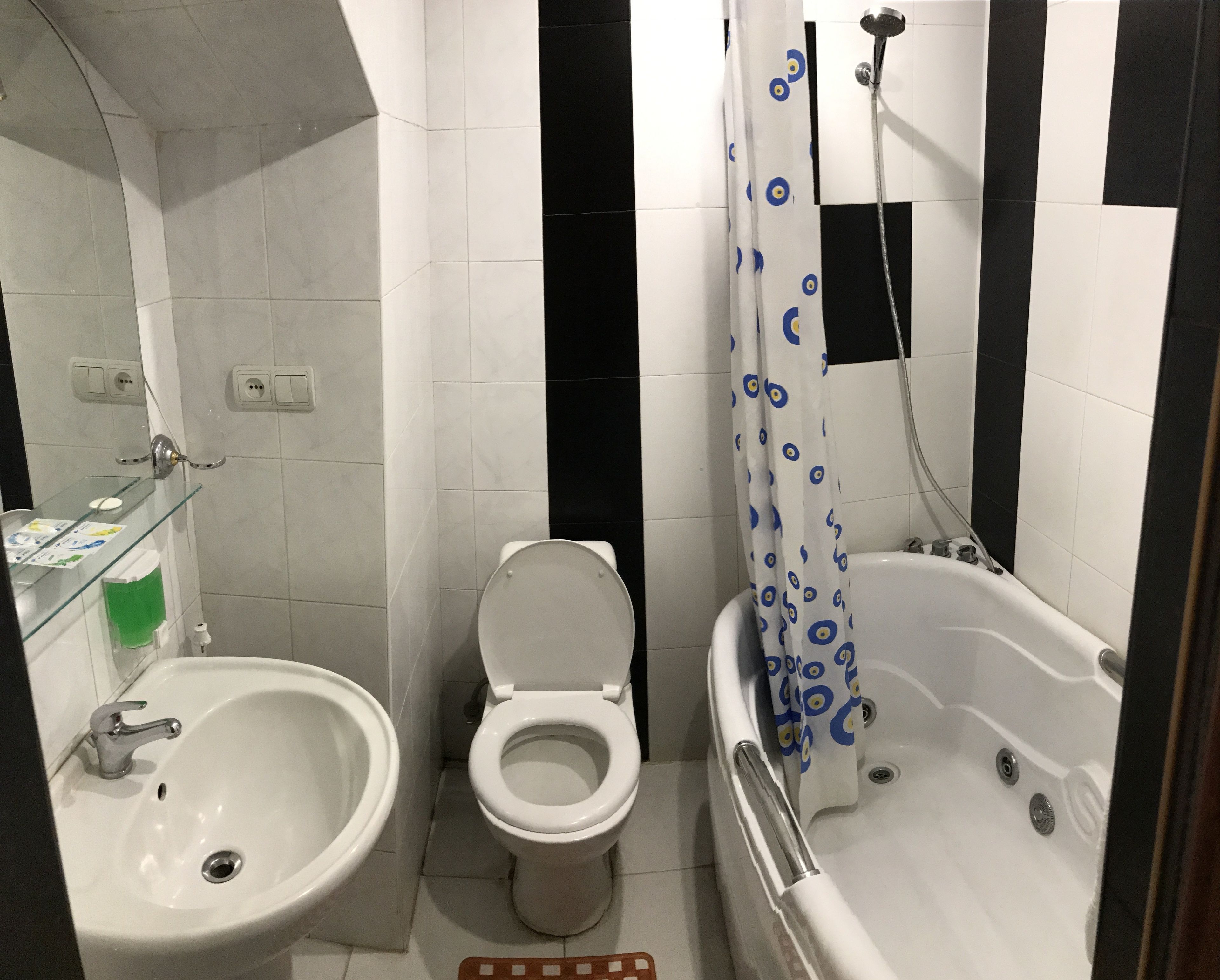 A bathroom with a sink, toilet, and bathtub.