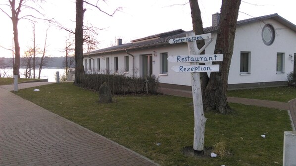 A building with a sign indicating a restaurant and reception.