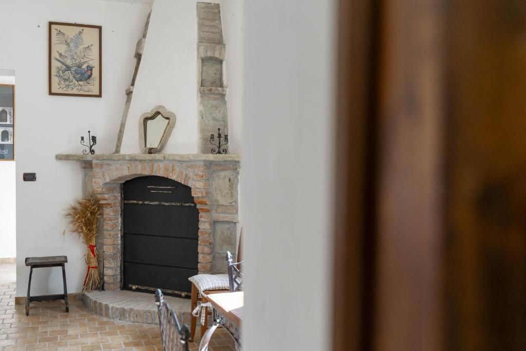 A room with a fireplace, a mirror, and a framed picture on the wall.