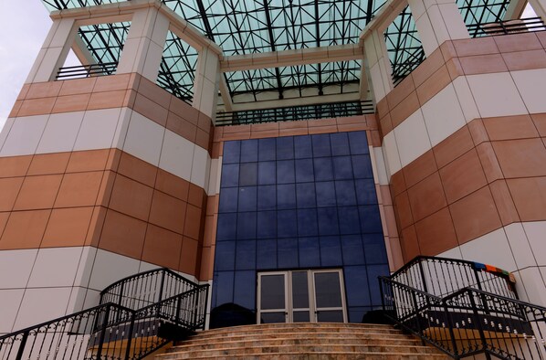 A modern building with a glass-paneled entrance and a geometric facade. - Statement Hotel (Abuja)