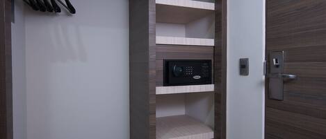 A modern closet with built-in shelves, a shoe rack, and a digital lock.