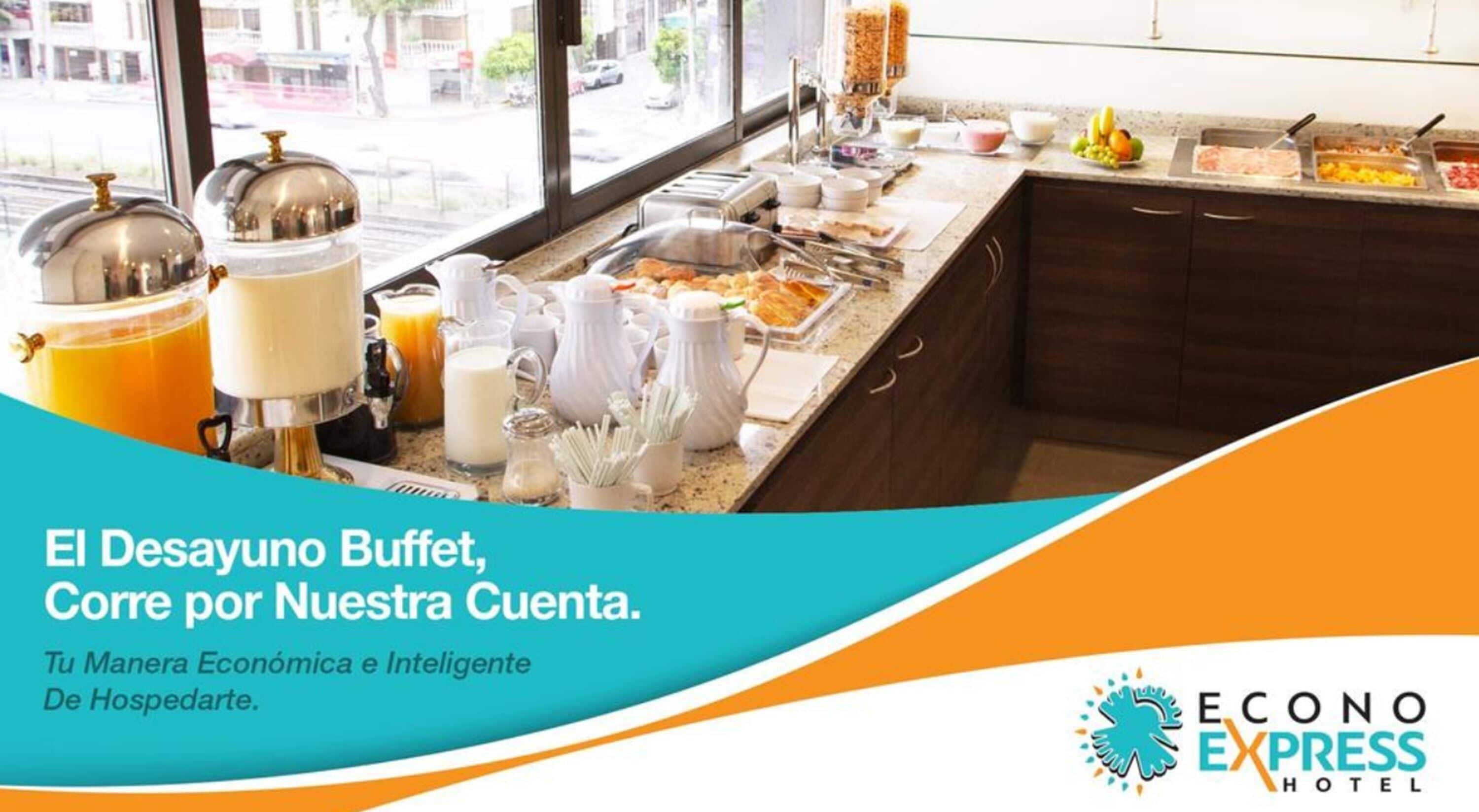 A buffet setup with various food items and beverages, including fruits, meats, and dairy products, displayed on a counter with a view of the street outside.