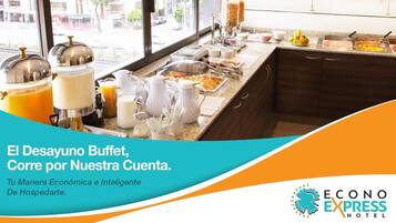 A buffet setup with various food items and beverages, including fruits, meats, and dairy products, displayed on a counter with a view of the street outside.