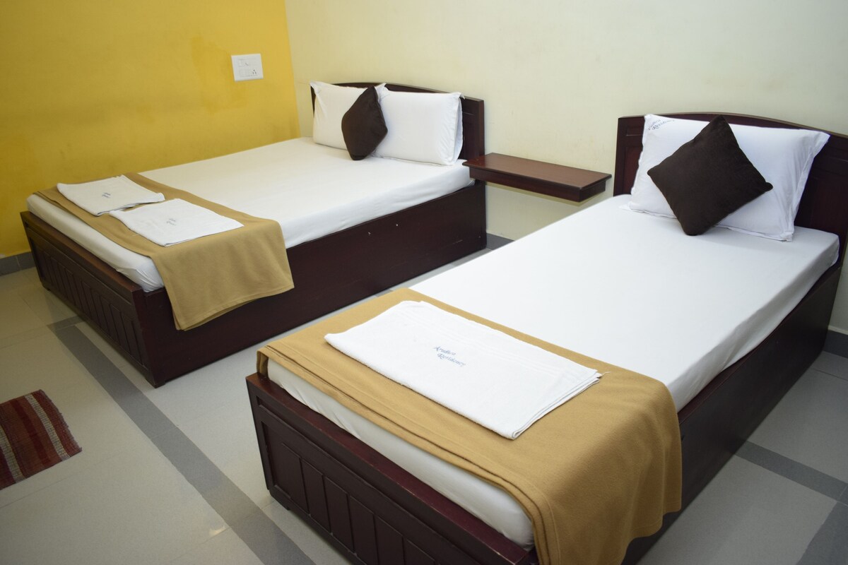Two single beds with wooden frames, white linens, and brown headboards.