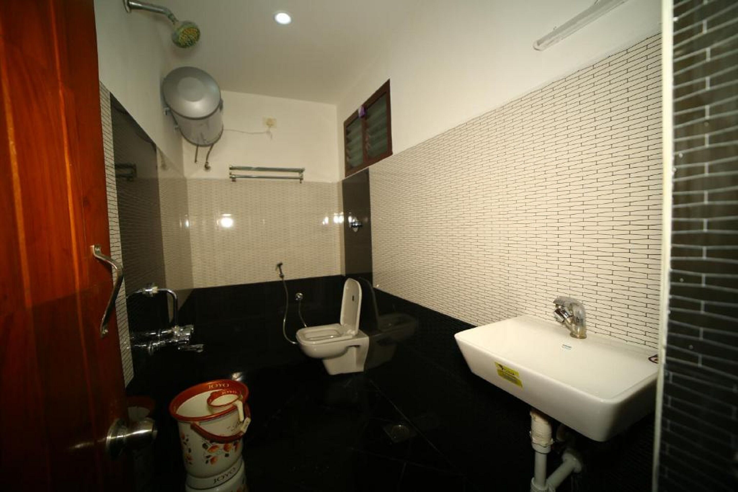 A bathroom with a toilet, sink, and shower.