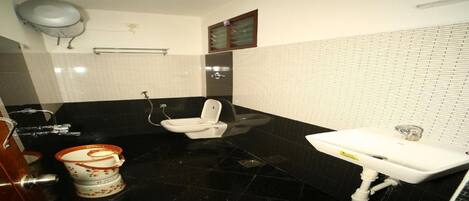 A bathroom with a toilet, sink, and shower.