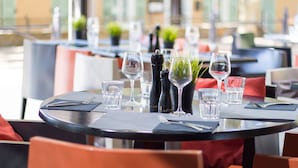 A dining table set with glasses, a salt and pepper shaker, and a small potted plant. - Hostellerie du Cigalou (Bormes-Les-Mimosas)