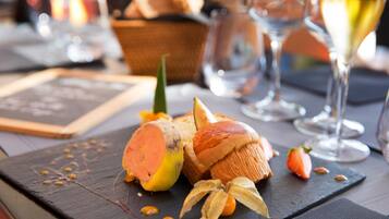 A dessert plate with a sweet potato, bread, and a banana on a slate board.