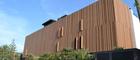 A modern building with a wooden facade and multiple windows.