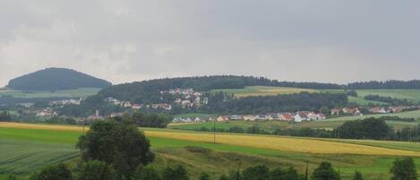 A rural landscape with a village and fields.