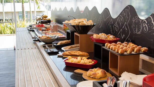 A buffet setup with various food items and a chalkboard with the words "ENJOY" and "63" visible. - ibis Itatiba (Itatiba)