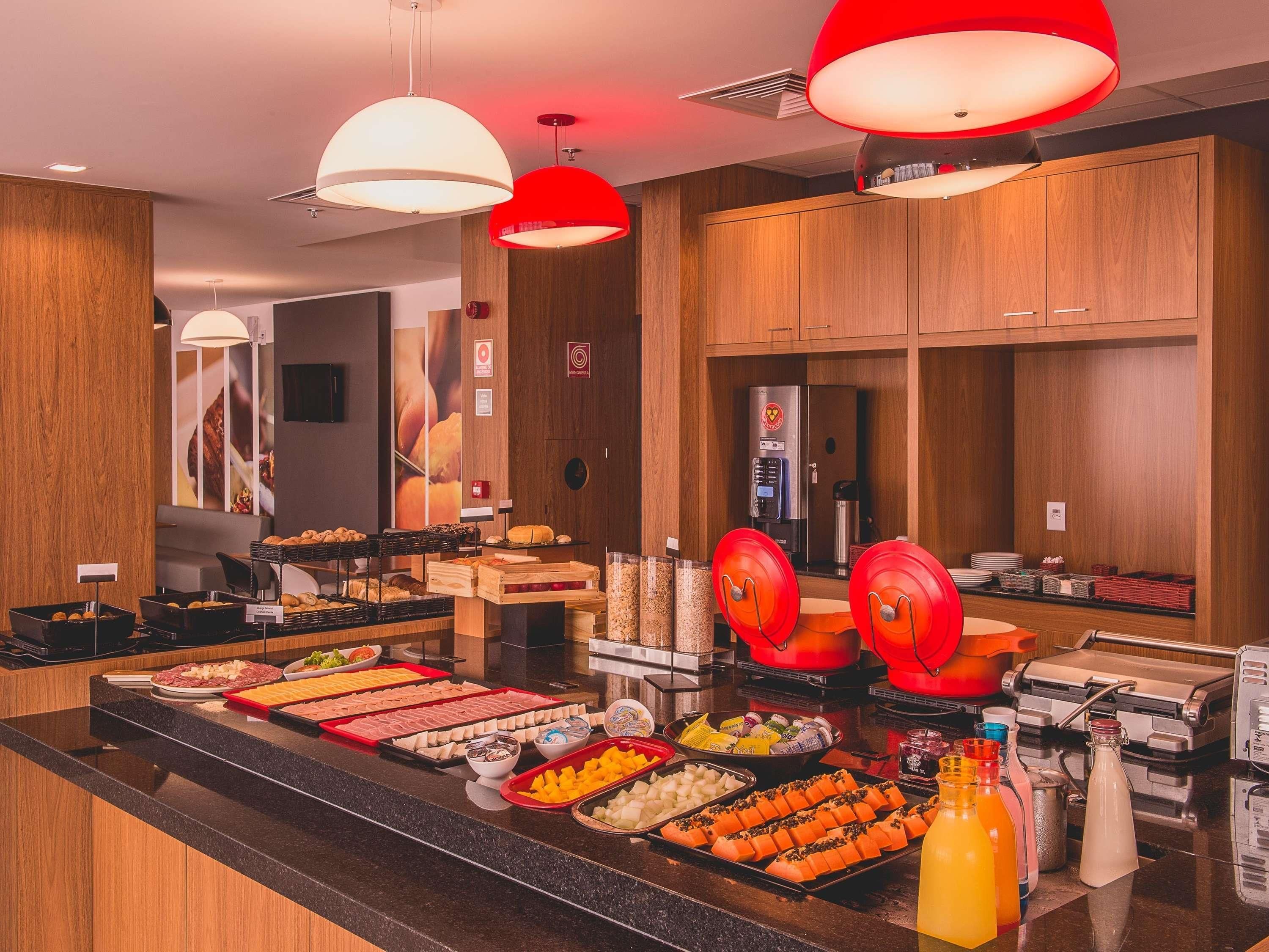 A buffet area with various food items and a coffee machine.