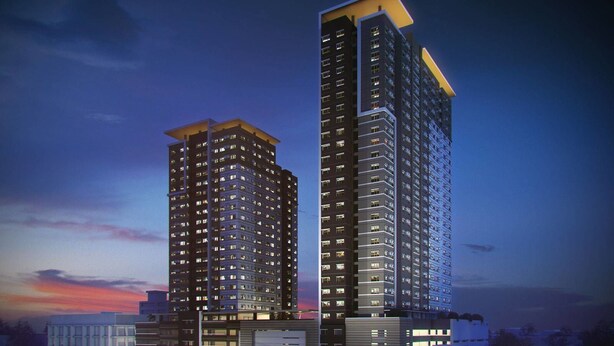 Two high-rise buildings with multiple floors, likely residential or mixed-use, with illuminated windows and a modern architectural design. - Roy's Condo Pad (Davao)