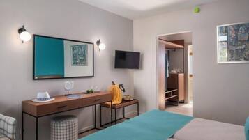 A modern bedroom with a bed, bedside table, and a TV.