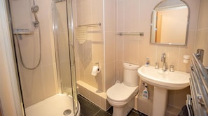 Separate bathtub and shower, towels