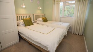 2 dormitorios, tabla de planchar con plancha, ropa de cama